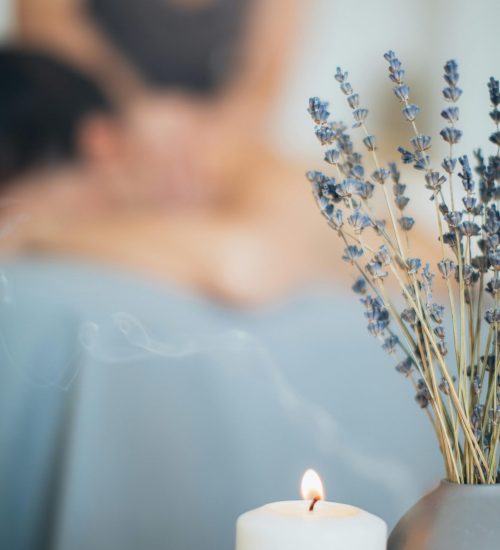 A soothing massage setting with lavender and candlelight for relaxation and aromatherapy.